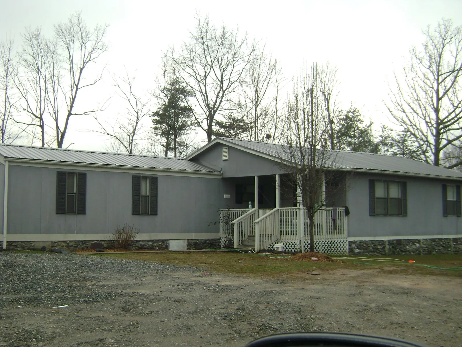 Metal roof over a manufactured home with a covered front porch in Tyngsboro