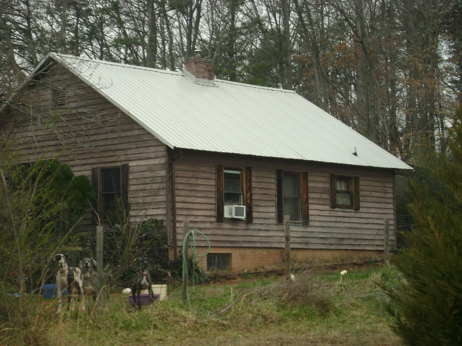 White metal roof on an old wood sided farmhouse, from a Metal Roof Installation job in Tyngsboro